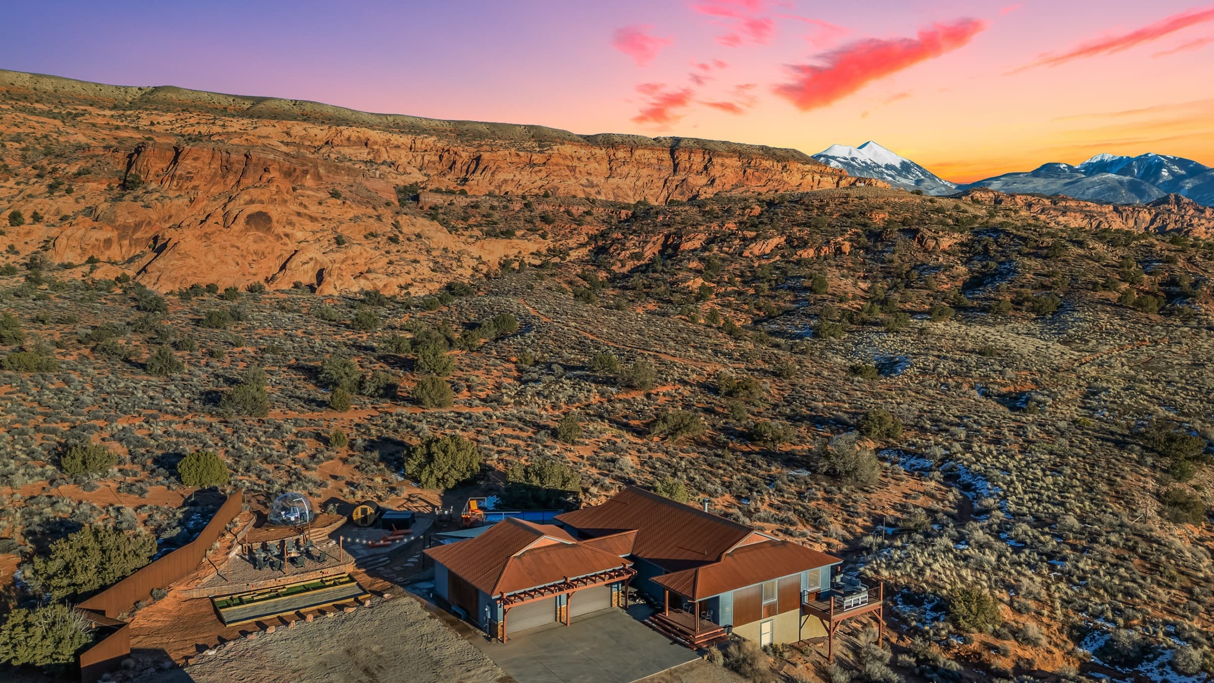 Twilight aerial of a luxury Moab Airbnb